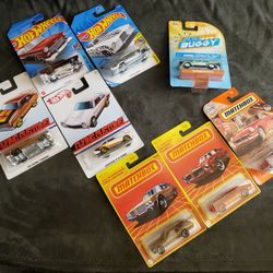 Assorted Hot Wheels and Matchbox toy cars.