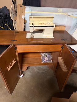 Sewing machine with built in cabinet