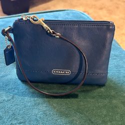 Vintage COACH blue leather wristlet with brass hardware.