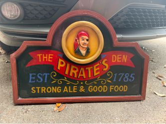 Wooden pirates den sign
