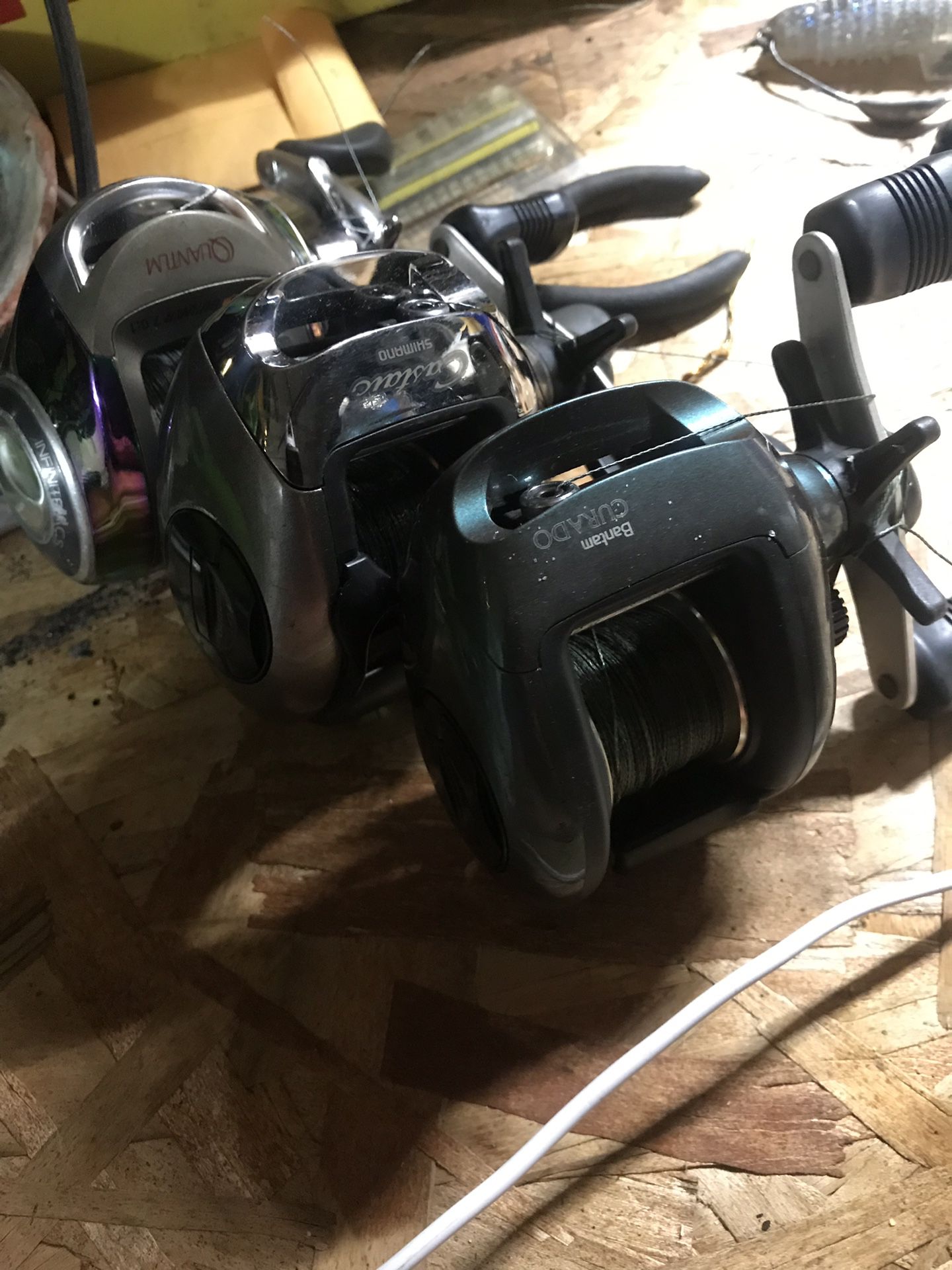 Three right hand reels two shimano curados and one quantum burner