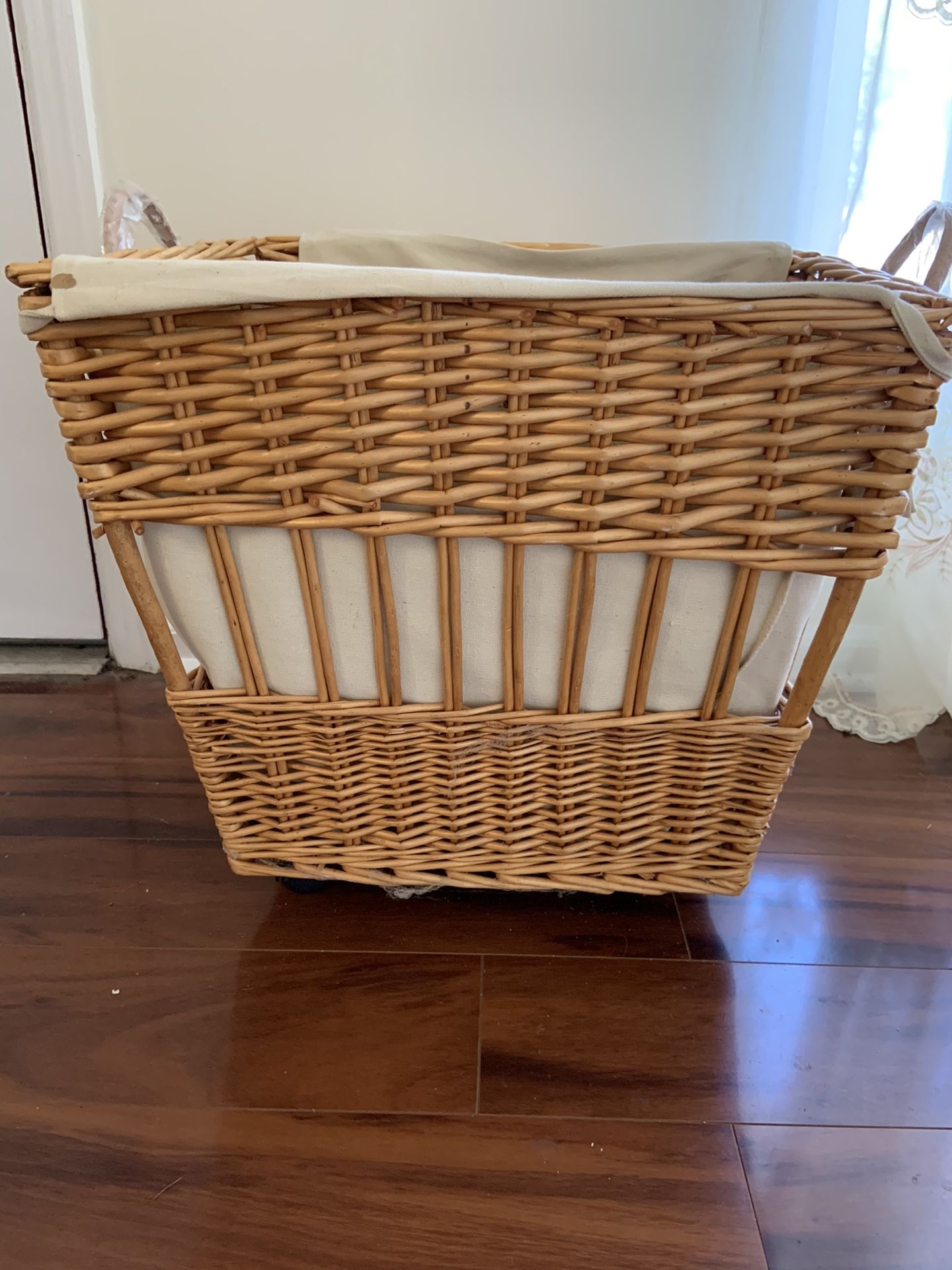 Wicker hamper or toy box on wheels