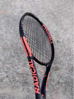 Wilson & Head Rackets and basket with tennis balls.