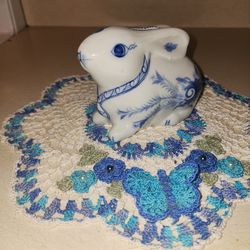 This is a Vintage  white and blue ceramic bunny rabbit figurine  & coin bank