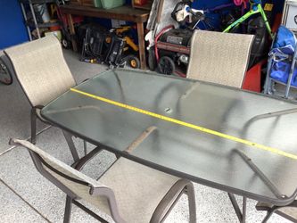 Outdoor glass table and four chairs by Foreclover glass and metal outdoor patio set.  Table is 72” in length Heavy duty set, real glass top, metal cha