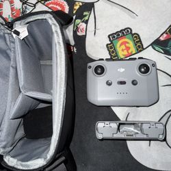 DJI remote, 2 batteries, battery pack, and carrying bag. 