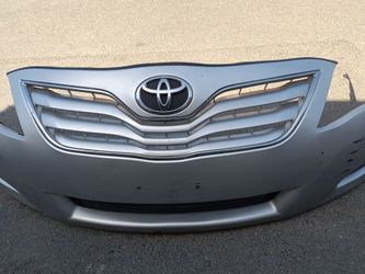 2010-2011 Toyota Camry complete front bumper with All the accessories oem.