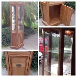 Curio solid wood display cabinet with shelves, a light and a cupboard