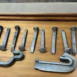 Vintage, forged steel blacksmithing spikes often repurposed for crafting, industrial-style decor, or heavy-duty outdoor use. 

•	Versatile Hardware: T