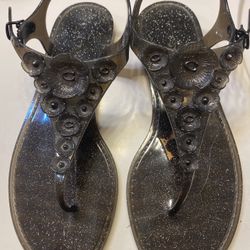 Coach glittery black jelly sandals. Signature Coach C logo in middle of flower.