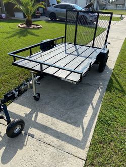 2024 5x8 Trailer 5-ft x 8-ft Steel Mesh Utility Trailer with Ramp Gate and a trailer dolly