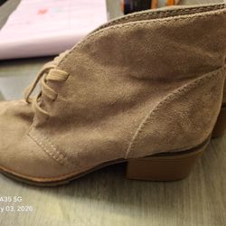 This is a pair of Merona tan faux suede lace-up ankle boots in size 7.5