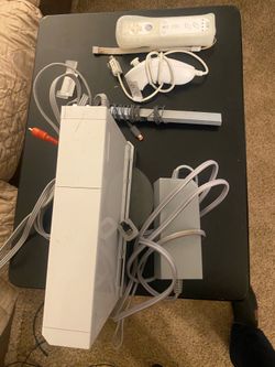 Wii console, one controller, various games , charging dock