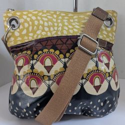Fossil Key-Per Coated Canvas Crossbody Bag, which features a vibrant, multi-patterned design with silver-tone hardware and an adjustable strap. 
