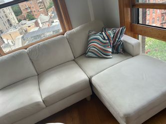 Modern white sectional sofa with chaise lounge in very good condition.