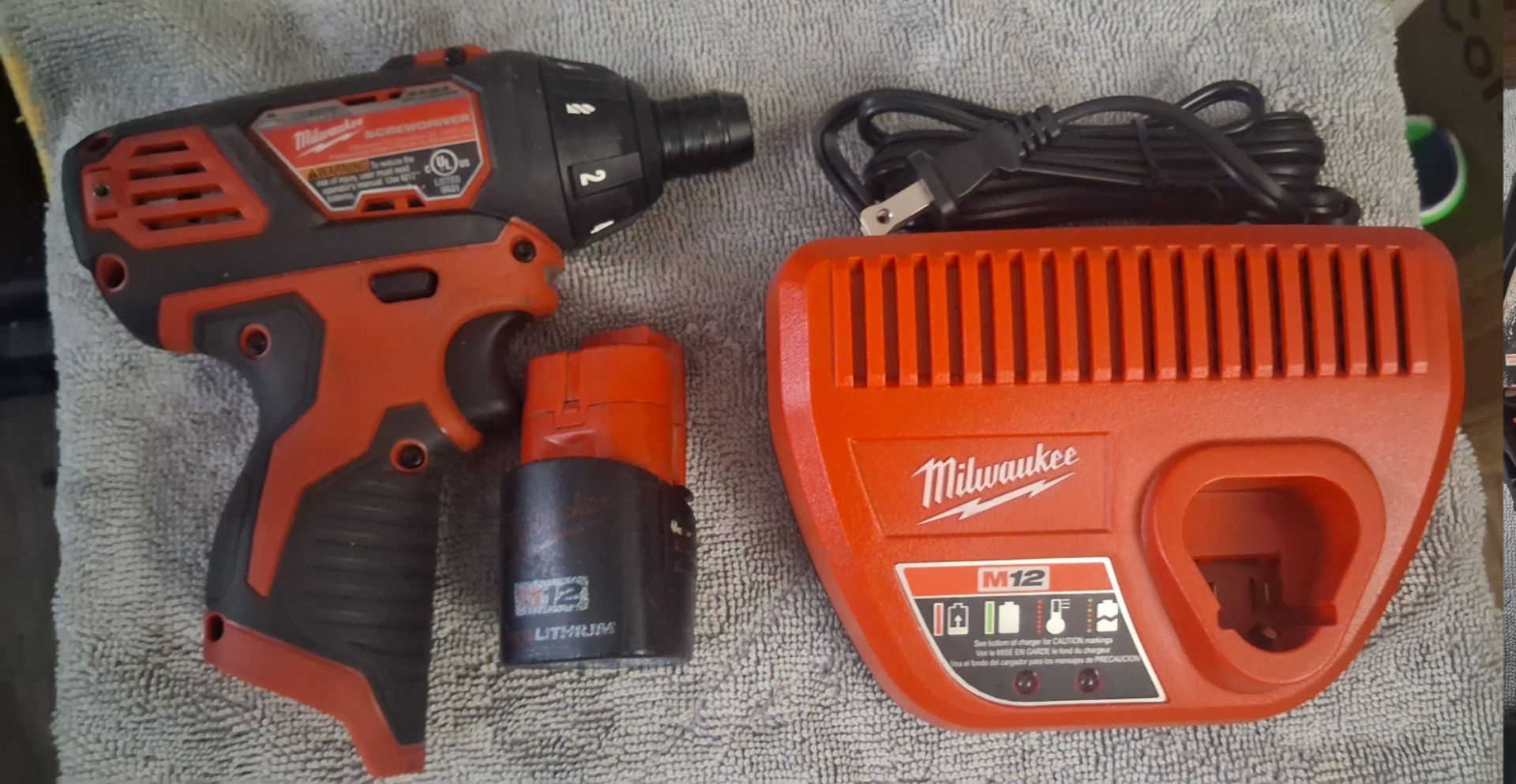 Milwaukee M12 2401-20 cordless screwdriver with battery and charger