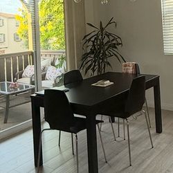 Ikea extendable table with 4 chairs in black