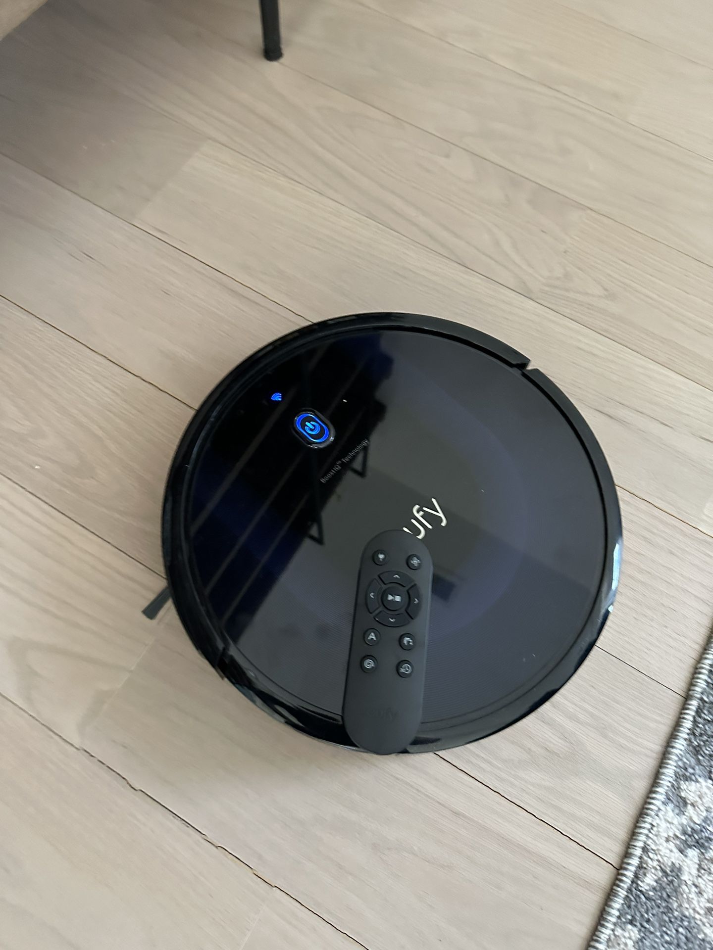 Title: Sleek Black Robotic Vacuum Cleaner with Dock and Remote 