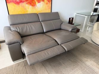 Living Room with Leather love seat and chair recliners, two accent chairs and TV stans