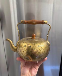 Brass kettle with wooden handle