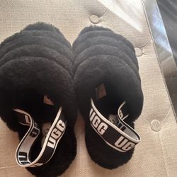UGG black furry with thick ankle strap size 6