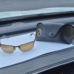 Ray-Ban RB3183 014/84 or RB3217 series featuring a brown/bronze metal frame and gradient polarized lenses.
