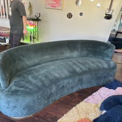 Curved crescent velvet sofa- designer statement piece with quilted base.