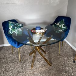 Modern Gold Glass Table And Blue Chairs 