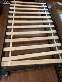 Twin size bed frame with mattress holding wood