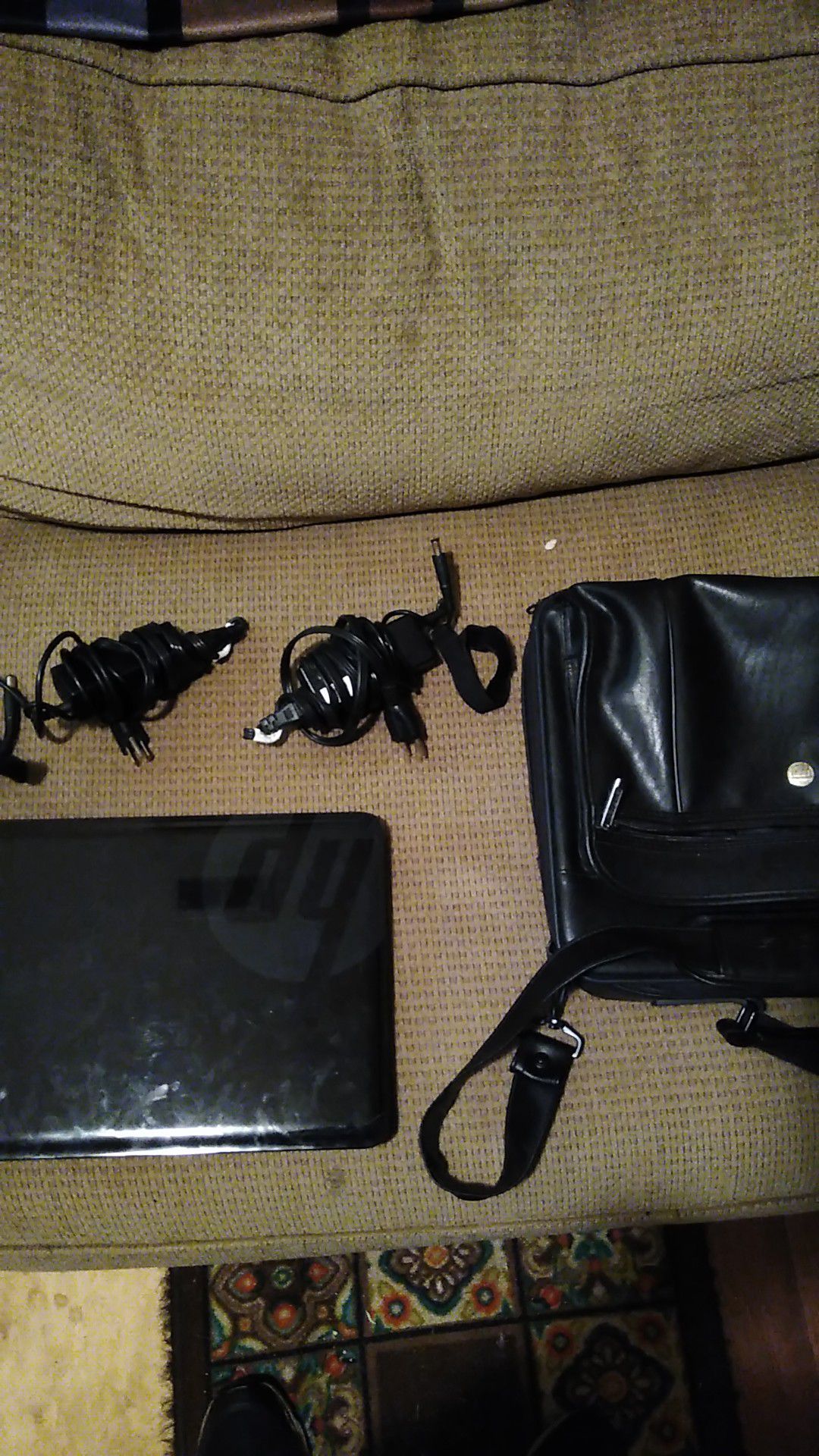 HP laptop with two chargers and laptop case