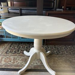 Small white pedestal dining table