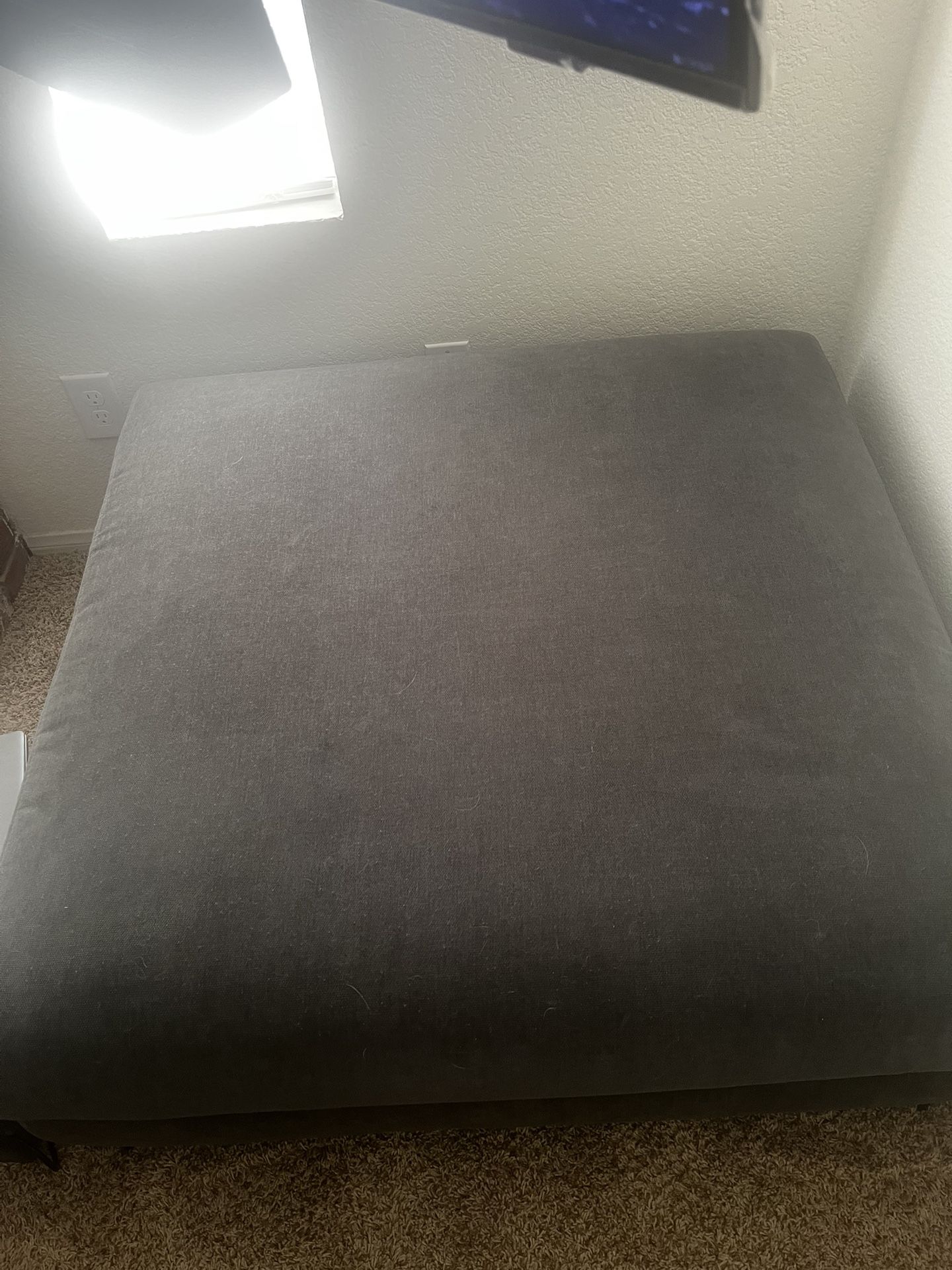 blue square ottoman with black legs