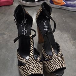 The product is a pair of Jessica Simpson "Dany" platform sandals in size 10. These stylish sandals feature a solid silver color with a strappy design 