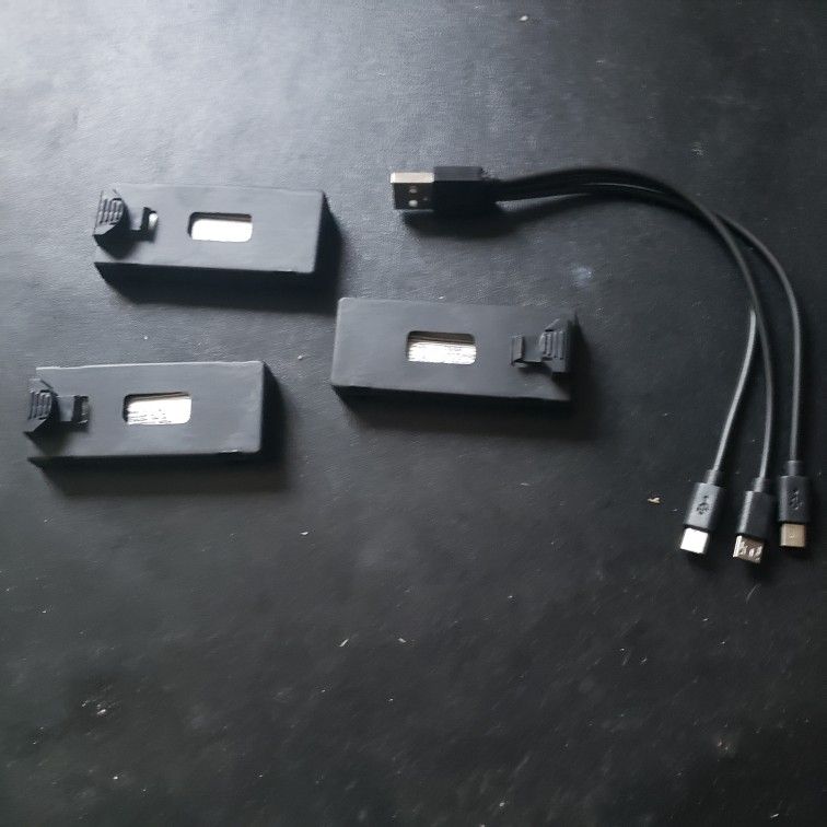 THREE BRAND NEW DRONE BATTERIES AND CHARGER CABLE