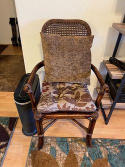 A pair of rattan chairs  with chair pad and pillow. Very unique excellent condition brown stained 75th Ave., Beardsley. At 1:01.