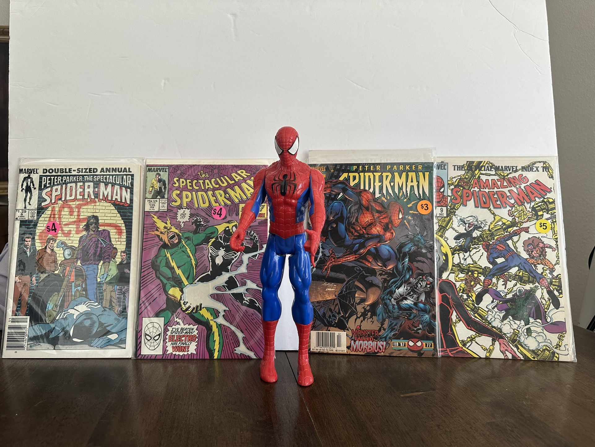 Vintage Spider-Man comic books and one Spider-Man action figure