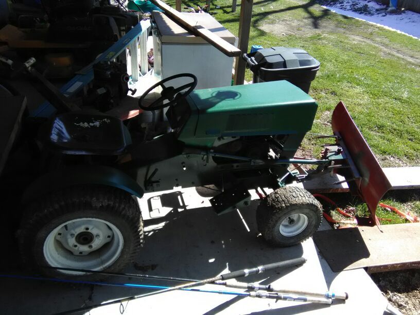 Old tractor with plow runs and plows