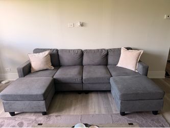 Grey couch with two ottomans