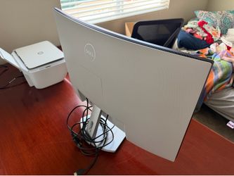 Dell  curved computer monitor and HP printer.