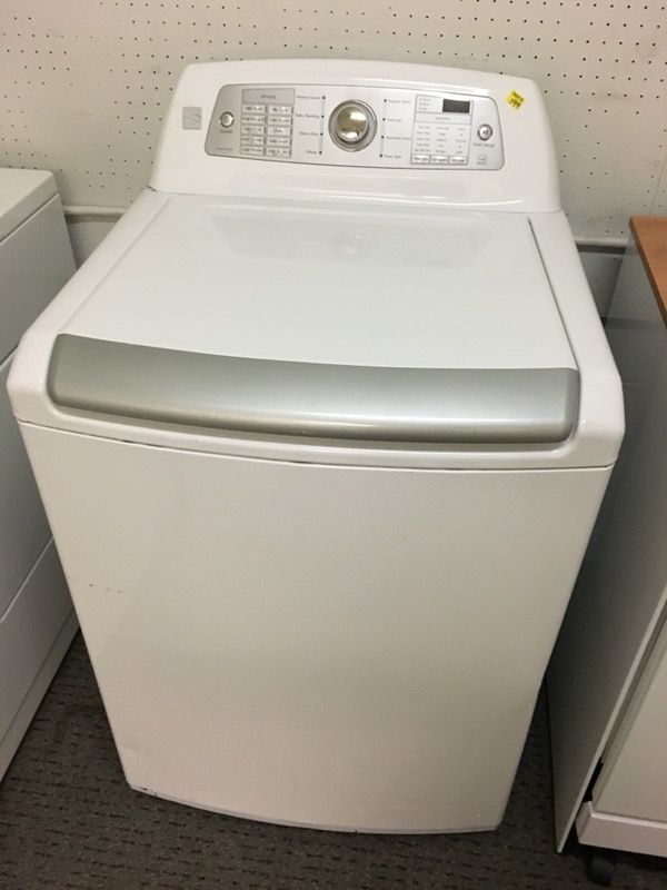Top load stainless steel Kenmore elite washing machine with a warranty