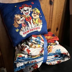 A set of children's bedroom items featuring a *Paw Patrol* animated series theme. The products include a decorative cushion and a matching bedding set