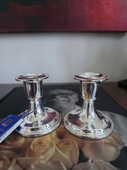 Pair of International Silver Company silver-plated candlesticks with a ridged edge design.