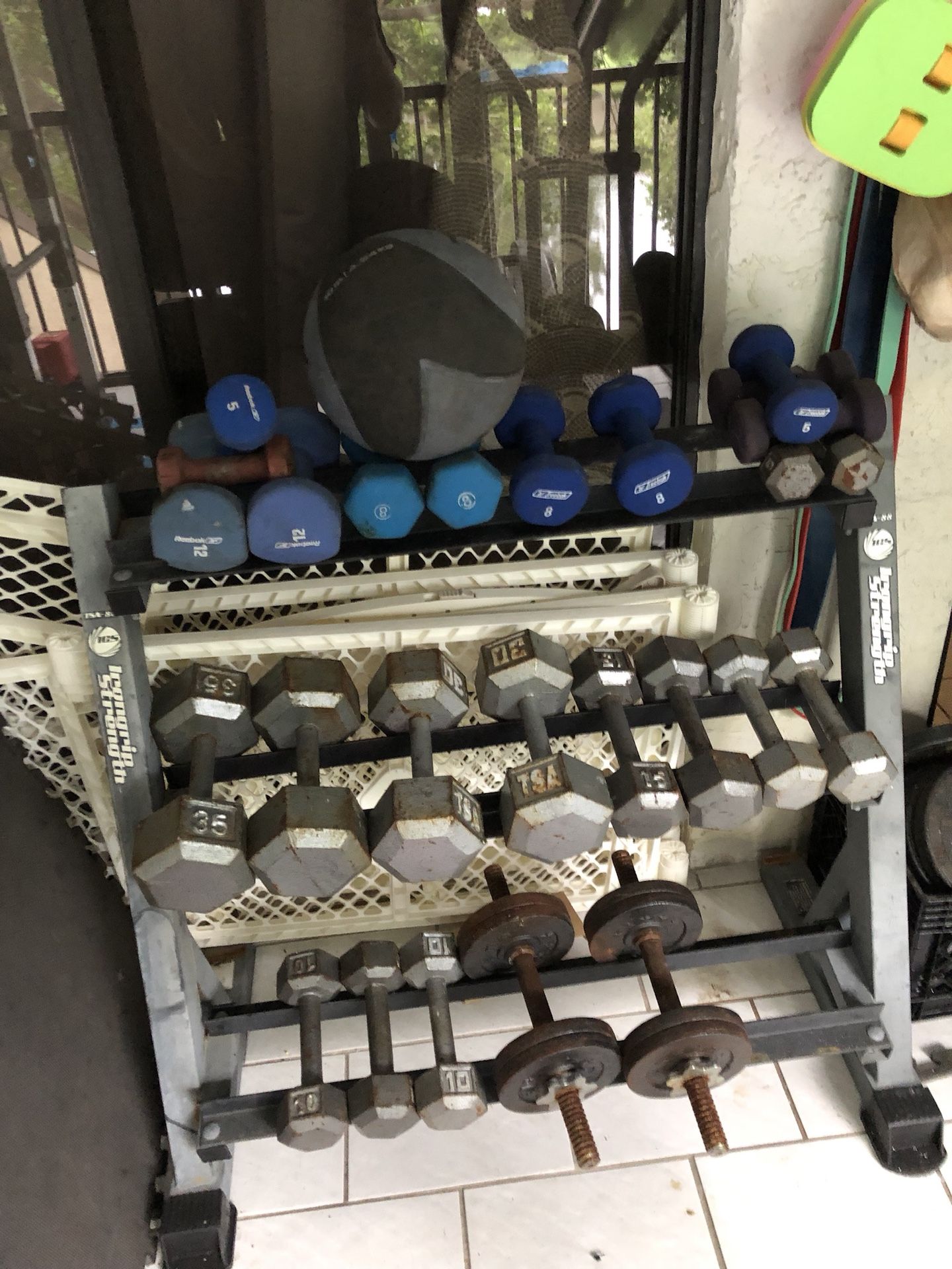 Dumbbell rack with a bunch of weights Great for exercise essential piece of gym equipment can be used if you went with your bench press or your weigh