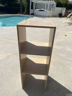 Two tan shelves with lamp