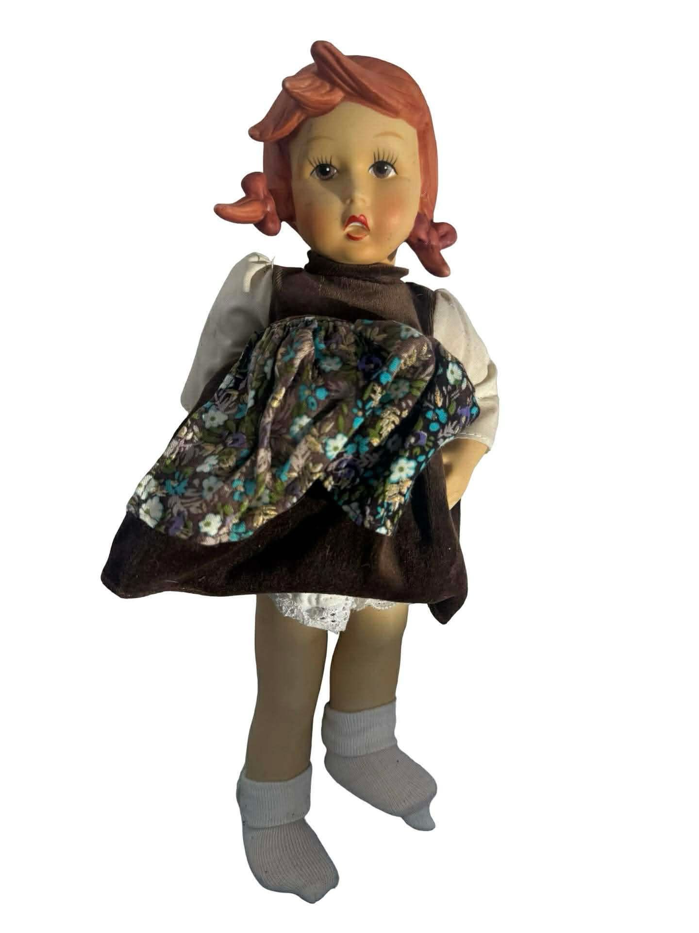 vintage porcelain or ceramic doll, possibly a "Heidi" or "German Girl" style doll.