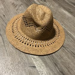 Tan straw hat with pearl embellishments