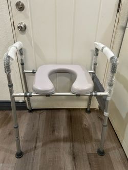 Raised toilet seat with handles