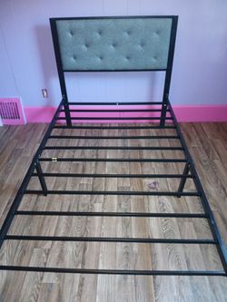 Twin bed with tufted headboard