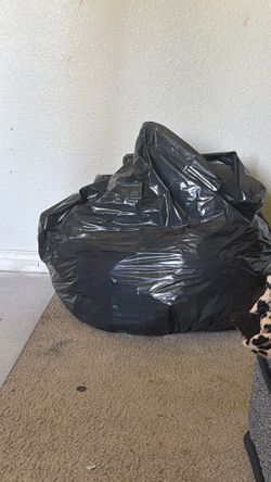 Big bag of clothes shirts jeans etc