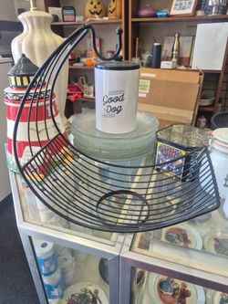 vintage black wire basket features a hanging hook for bananas and a crescent-shaped design for holding fruit.
